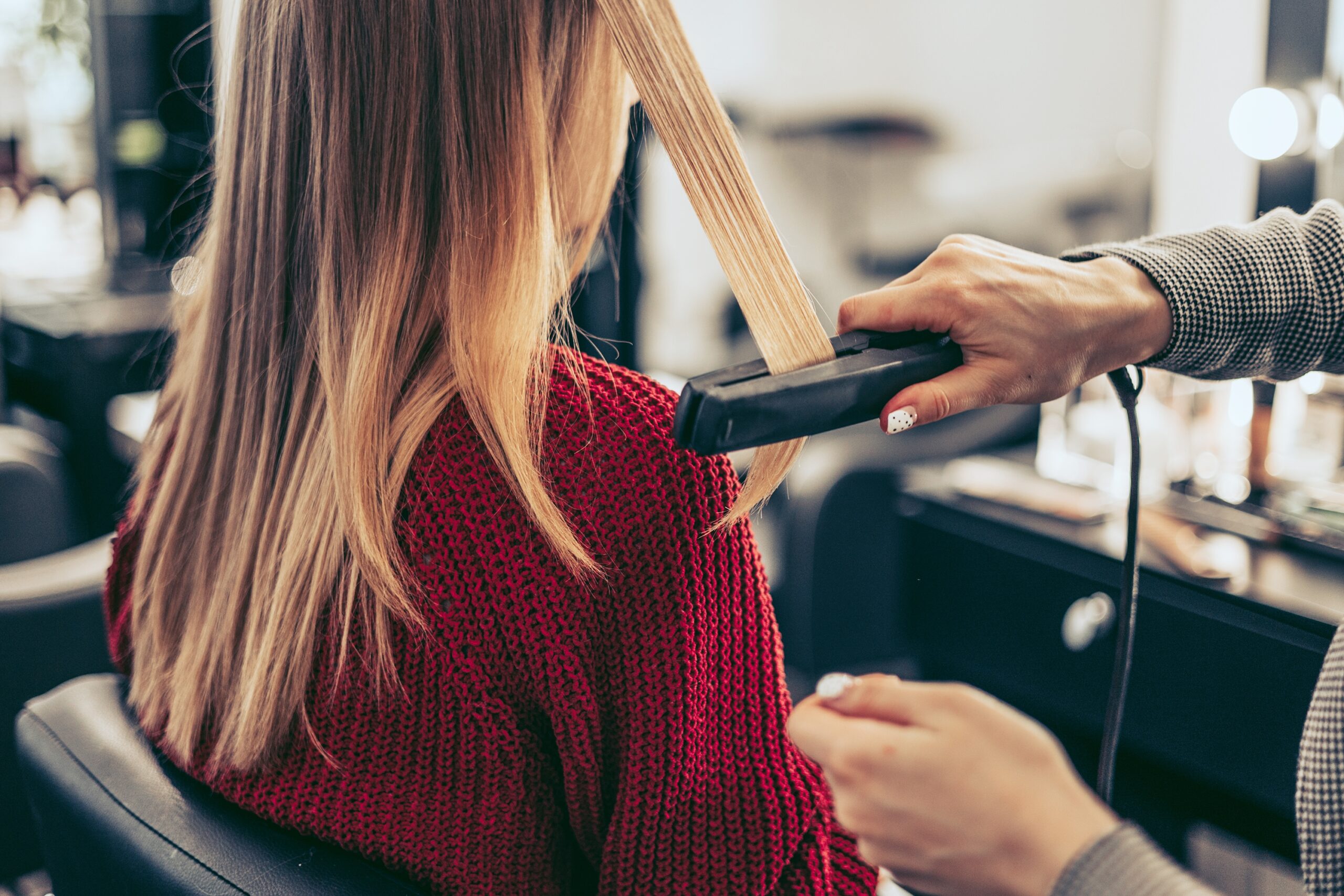 the-process-of-straightening-hair-with-an-iron-in-2023-11-27-05-22-25-utc